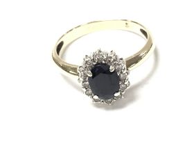 9ct yellow gold oval sapphire and RC diamond ring.