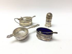 A collection of silver cruet items and strainer. B