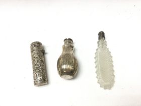 A collection of 3 silver perfume bottles. Inc cut