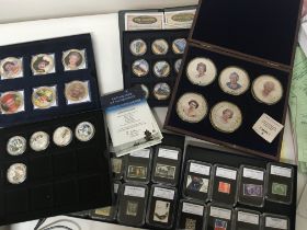 A collection of cased gold plated collectors coins