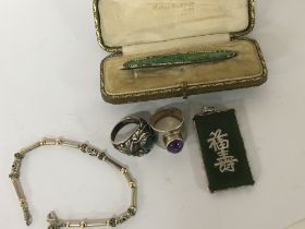 A Chinese jade pendent two silver rings set with C
