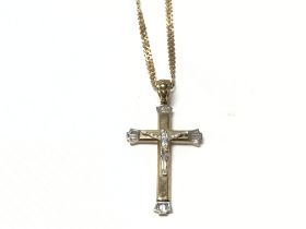 A 9ct gold cross pendant on a 9ct gold chain. Tota