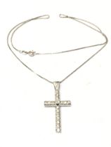 An 18ct white gold cross pendant , 9.5g. Postage c