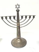 A Silver Menorah with nine candle holders loaded b