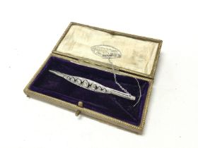 A 18ct white gold Art Deco brooch, Inset with 7 ro