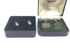 A pair of 14k gold drop earrings set with aquamari