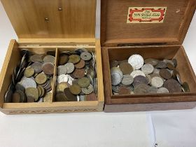 A large folder of coins with boxes of loose coinag