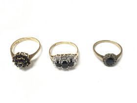 Three 9ct gold rings set with garnet and other gem