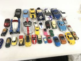 A collection of 33 Playworn model cars of varying