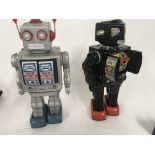 A pair of tinplate model battery operated robots w