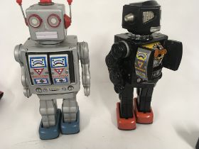 A pair of tinplate model battery operated robots w