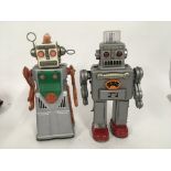 A pair of tinplate battery operated robots one mar