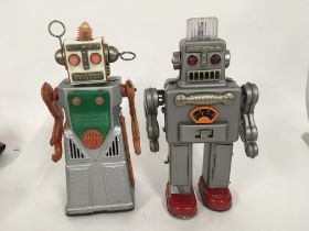 A pair of tinplate battery operated robots one mar