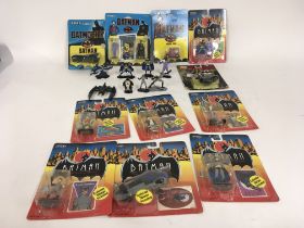 A collection of Batman figures. 11 carded unopened figures by ERTL. Also 8 loose ERTL figures.