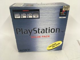 Boxed PlayStation One with two controllers 3 memory cards and associated cables.