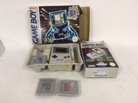 Boxed Nintendo gameboy with Tetris, power supply missing. Includes light magnifier and two
