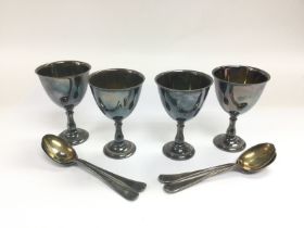 A silver plated chalice style egg cups and spoons
