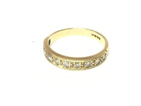 An 18ct gold half hoop eternity ring. Size P and 3