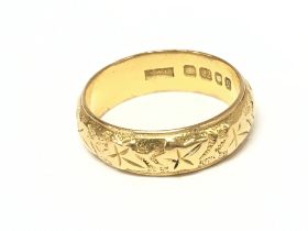 A 22ct gold wedding band. Size T and 9.37g Postage