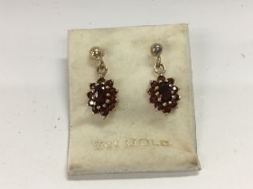 A pair of 9ct gold garnet set earrings.