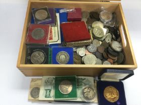 A wooden case of mixed coinage including old and c