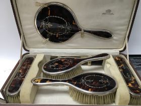 A tortoiseshell and silver dressing table set comp