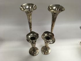 Two pairs of silver vases and a silver trophy.