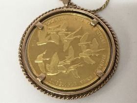 A Canadian 100 dollar coin in a 10ct mount with 10