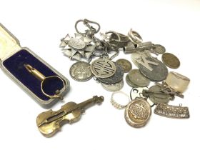 A collection of some silver including coins, badge