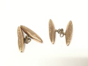 A pair of vintage 9ct gold cufflinks. One in need