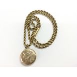 9ct yellow gold (unmarked) round engraved locket,