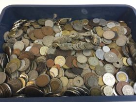 A tray of mixed foreign coins. Postage B