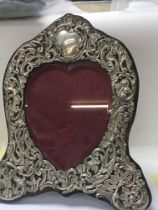 A heart shape photo frame with silver front and oa