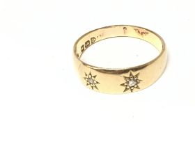 An 18ct gold ring set wit( two small diamonds. Siz