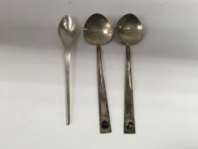 Three arts and crafts style spoons.