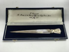 A commemorative silver hallmarked letter opener.