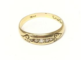 An 18ct gold ring set with a row of small diamonds