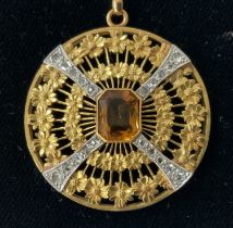 A circular 18ct gold and diamond pendant with a ce