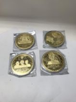 A collection of large gold plated commemorative me