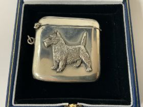 A hallmarked silver vesta case with an applied sil