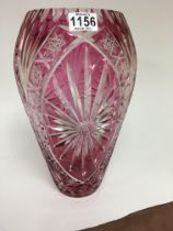 A Ruby cut glass vase with star cut design. 38 cm