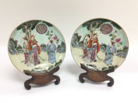 A pair of famille rose dishes decorated with figur