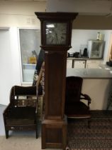 An oak cased 30 hour long case clock with a silver