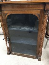 A Victorian oak cabinet the single door enclosing