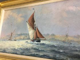 A gilt framed oil on canvas depicting boats in rou