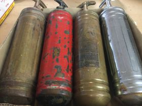 A collection of vintage brass car fire extinguishe