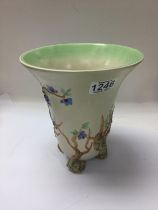 A Clarice cliff vase decorated with flowers and fo