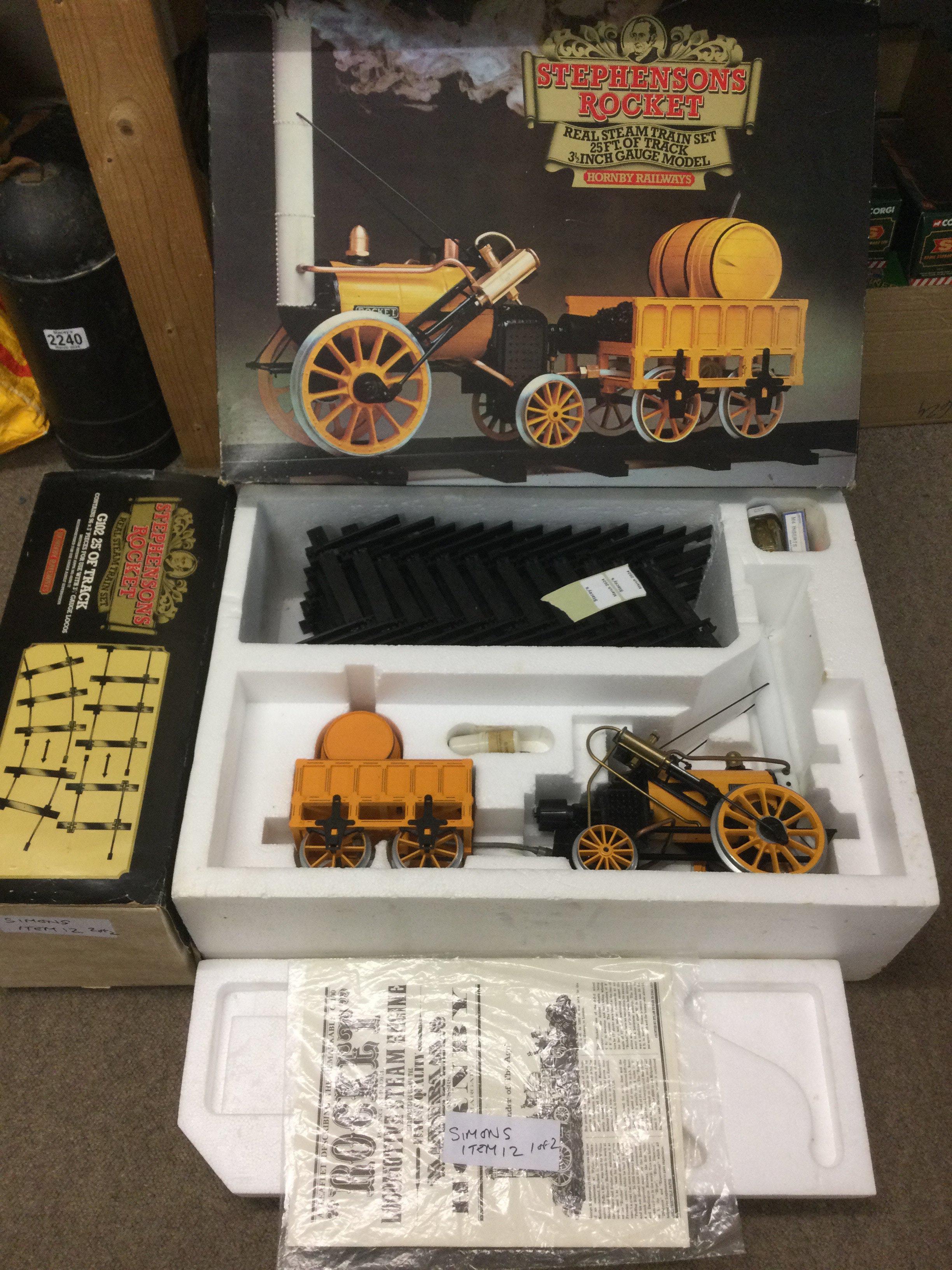 A boxed Hornby Stephenson's Rocket steam train set and a track extension set (2). Shipping