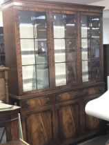 A mahogany reproduction display cabinet with glass