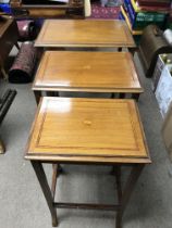 An Edwardian inlaid mahogany nest of tables.